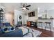 Cozy living room with modern furniture, a TV, and an open view to the kitchen at 1810 E Palm Ave # 4304, Tampa, FL 33605