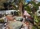 Backyard featuring lush landscaping, rock water feature, and outdoor kitchen area at 1874 N Washington Ave, Clearwater, FL 33755