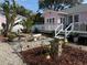 Lush backyard with a stone patio, water feature, mature trees, and cottage-style landscaping at 1874 N Washington Ave, Clearwater, FL 33755