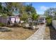 Charming backyard with lush landscaping and multiple seating areas at 1874 N Washington Ave, Clearwater, FL 33755