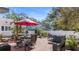 Outdoor brick patio featuring a seating area, grill, and lush landscaping for backyard entertaining at 1874 N Washington Ave, Clearwater, FL 33755