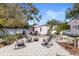 Backyard featuring gravel, a firepit with chairs, and lush landscaping at 1874 N Washington Ave, Clearwater, FL 33755