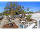 Spacious backyard with gravel seating areas, a water feature, landscaping, and a pink sun umbrella at 1874 N Washington Ave, Clearwater, FL 33755