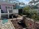 Landscaped backyard featuring a patio, water feature, and lush greenery at 1874 N Washington Ave, Clearwater, FL 33755