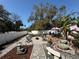 Spacious backyard with decorative landscaping, multiple seating areas and white privacy fence at 1874 N Washington Ave, Clearwater, FL 33755