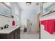 Stylish bathroom with a black vanity, tiled floors, and white paneled walls, exuding a fresh ambiance at 1874 N Washington Ave, Clearwater, FL 33755