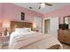 Cozy bedroom with pink walls, a comfortable bed, and warm lighting at 1874 N Washington Ave, Clearwater, FL 33755