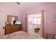 Comfortable bedroom featuring bright colors and sunroom access at 1874 N Washington Ave, Clearwater, FL 33755