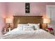 Relaxing bedroom featuring a stylish headboard, bedside lamps, and elegant decorative accents at 1874 N Washington Ave, Clearwater, FL 33755