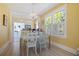 Bright dining room with a chandelier, large windows, and stylish furniture with an open flow to kitchen at 1874 N Washington Ave, Clearwater, FL 33755