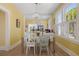 Bright dining room with a chandelier, large windows, and stylish furniture with an open flow to kitchen at 1874 N Washington Ave, Clearwater, FL 33755