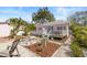 Charming pink home features a landscaped front yard with a welcoming porch and detailed garden at 1874 N Washington Ave, Clearwater, FL 33755