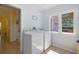 Bright laundry room featuring modern appliances and ample natural light from a window at 1874 N Washington Ave, Clearwater, FL 33755