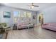 Cozy living room with a pink couch, light blue walls, and large windows at 1874 N Washington Ave, Clearwater, FL 33755