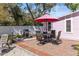 Brick patio area with a dining table and grill, perfect for outdoor entertaining at 1874 N Washington Ave, Clearwater, FL 33755