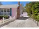 View of the side yard with a white picket fence and pink shed, adding to the property's charm at 1874 N Washington Ave, Clearwater, FL 33755