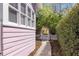 A charming side yard is finished with crushed rock path and a white picket fence at 1874 N Washington Ave, Clearwater, FL 33755