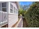Side view of the home with a stone walkway leading to a charming gate and garden area at 1874 N Washington Ave, Clearwater, FL 33755