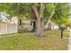 Quaint home featuring green shutters and a lush front yard with a beautiful mature shade tree at 1909 N Macdill Ave, Tampa, FL 33607