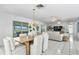 Open dining and living space with views of the waterfront patio and dock at 222 Mar St, St Pete Beach, FL 33706