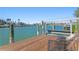 Wide angle view of a private dock with a boat lift and beautiful water views on a sunny day at 222 Mar St, St Pete Beach, FL 33706