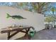 Charming backyard bar area, perfect for entertaining, featuring a rustic table with decor, and a decorative fish at 222 Mar St, St Pete Beach, FL 33706