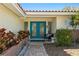 Inviting front entrance with vibrant blue double doors, brick accents, and manicured landscaping creating curb appeal at 222 Mar St, St Pete Beach, FL 33706