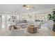 Spacious living room with neutral decor, tile floors, waterfront views, and ceiling fans, perfect for modern comfort at 222 Mar St, St Pete Beach, FL 33706