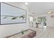 Open-concept living space with dining area, tile flooring, and bright natural light, perfect for modern living at 222 Mar St, St Pete Beach, FL 33706