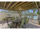 Relaxing outdoor dining area with seating for six, a covered patio, and waterfront views for casual meals at 222 Mar St, St Pete Beach, FL 33706