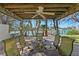 Charming outdoor dining area under a wooden pergola with water views, perfect for entertaining or relaxing at 222 Mar St, St Pete Beach, FL 33706