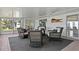 Relaxing patio area with four wicker chairs, a dark gray rug, and views of the outdoors through sliding glass doors at 222 Mar St, St Pete Beach, FL 33706