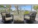 Inviting sunroom with cozy seating and serene water views through large windows, creating a relaxing retreat at 222 Mar St, St Pete Beach, FL 33706