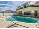 Relaxing screened-in pool and jacuzzi area with a safety fence for added security at 22819 Eagles Watch Dr, Land O Lakes, FL 34639