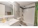 Clean bathroom featuring shower-tub combo with stylish decorative tile at 2625 State Road 590 # 2612, Clearwater, FL 33759