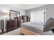 Bedroom showcasing a large dresser, mirror, window with blinds, and tiled flooring at 2625 State Road 590 # 2612, Clearwater, FL 33759