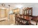 Dining area featuring a wooden table with chairs next to a china cabinet and an open kitchen area at 2625 State Road 590 # 2612, Clearwater, FL 33759