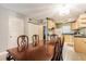 Inviting dining area with wood table and chairs adjacent to the kitchen with ample storage space and appliances at 2625 State Road 590 # 2612, Clearwater, FL 33759