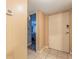 Hallway view showcasing the front door and an open doorway leading into a bedroom at 2625 State Road 590 # 2612, Clearwater, FL 33759