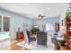 Comfortable living room with sliding glass doors to the pool, hardwood floors, and ceiling fan at 2712 Avon River Dr, Valrico, FL 33596