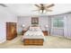 Bright main bedroom featuring a ceiling fan, artwork, and coordinated furnishings at 2712 Avon River Dr, Valrico, FL 33596