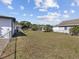 Large, fenced backyard with ample green space and mature landscaping at 2901 W Nassau St, Tampa, FL 33607