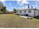 A view of the backyard featuring partial fencing, a well-maintained lawn, and trees at 2901 W Nassau St, Tampa, FL 33607