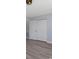 Bedroom featuring wood-look flooring, white trim, and closet with bi-fold doors at 2901 W Nassau St, Tampa, FL 33607