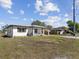 Charming home with an inviting white exterior, well-manicured lawn, and black shutters at 2901 W Nassau St, Tampa, FL 33607