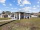 Charming home with a covered carport and well-manicured lawn with an inviting white exterior at 2901 W Nassau St, Tampa, FL 33607