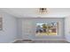 Bright living room featuring hardwood floors, neutral paint, and contemporary light fixture at 2901 W Nassau St, Tampa, FL 33607
