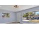 Bright living room featuring hardwood floors, natural light, and contemporary light fixture at 2901 W Nassau St, Tampa, FL 33607