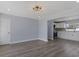 Spacious living room featuring hardwood floors, neutral paint, and modern light fixture at 2901 W Nassau St, Tampa, FL 33607
