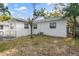 A view of the backyard with the white home and lush landscaping at 2910 N 17Th St, Tampa, FL 33605